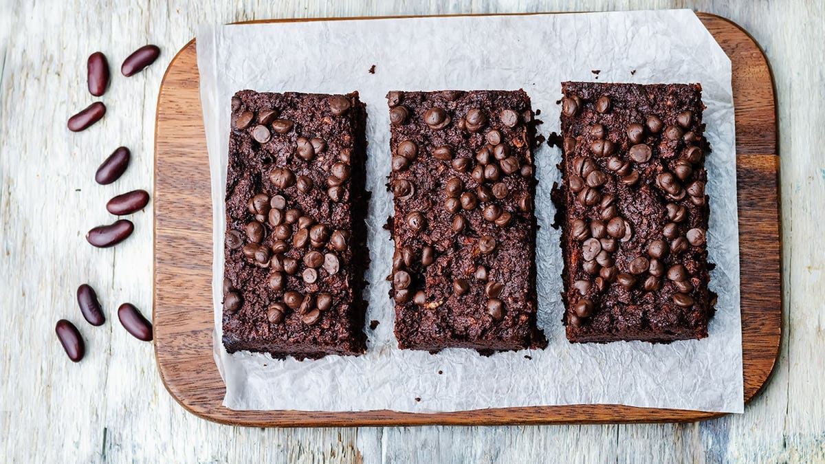 Red beans chocolate chips brownie on white wood background