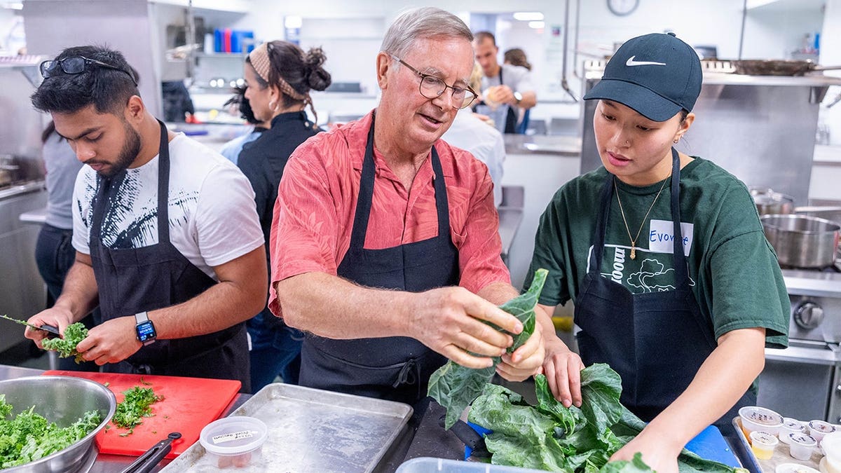 Dr. Ron Quinton, medical director of Tulane University’s Goldring Center for Culinary Medicine, working with students in teaching kitchen.