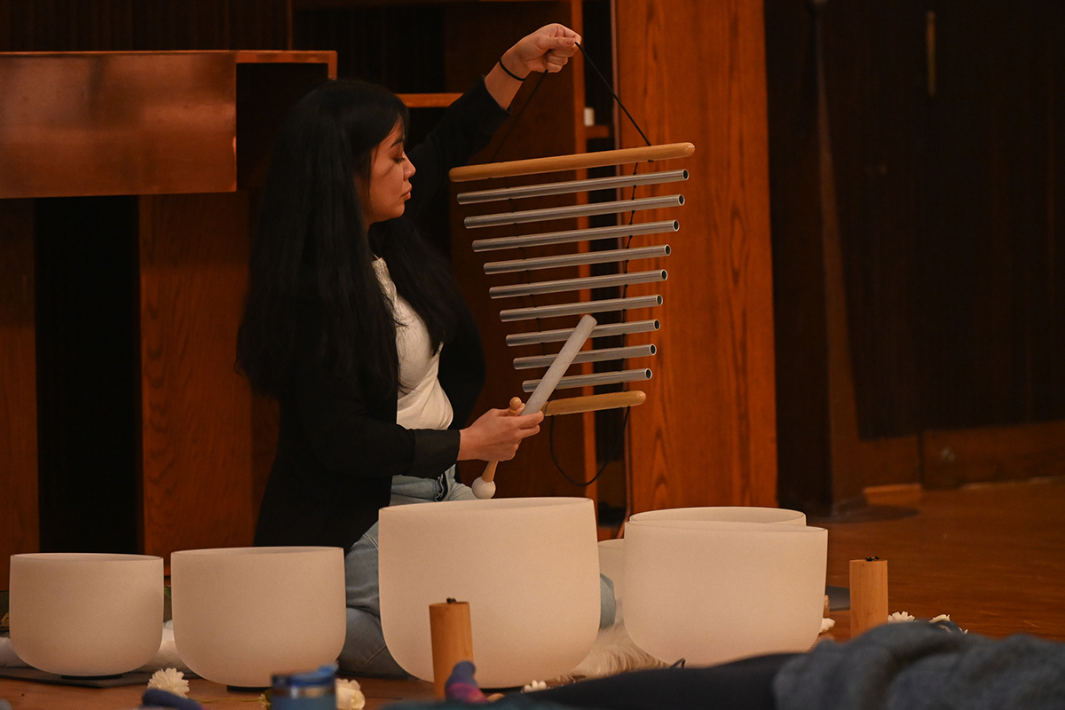 woman playing chimes for sound bath