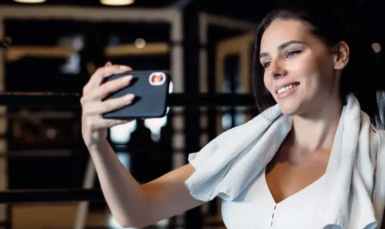 sporty woman taking selfie with mobile phone social networks