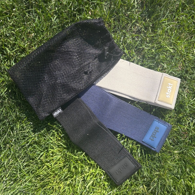 Three resistance bands laying on grass