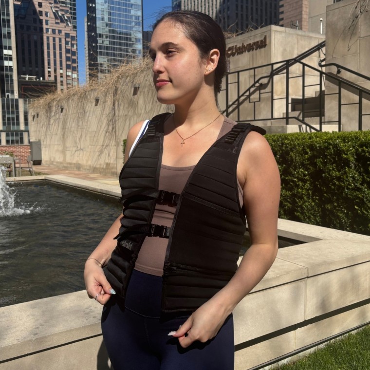 Woman wearing black weighted vest outside