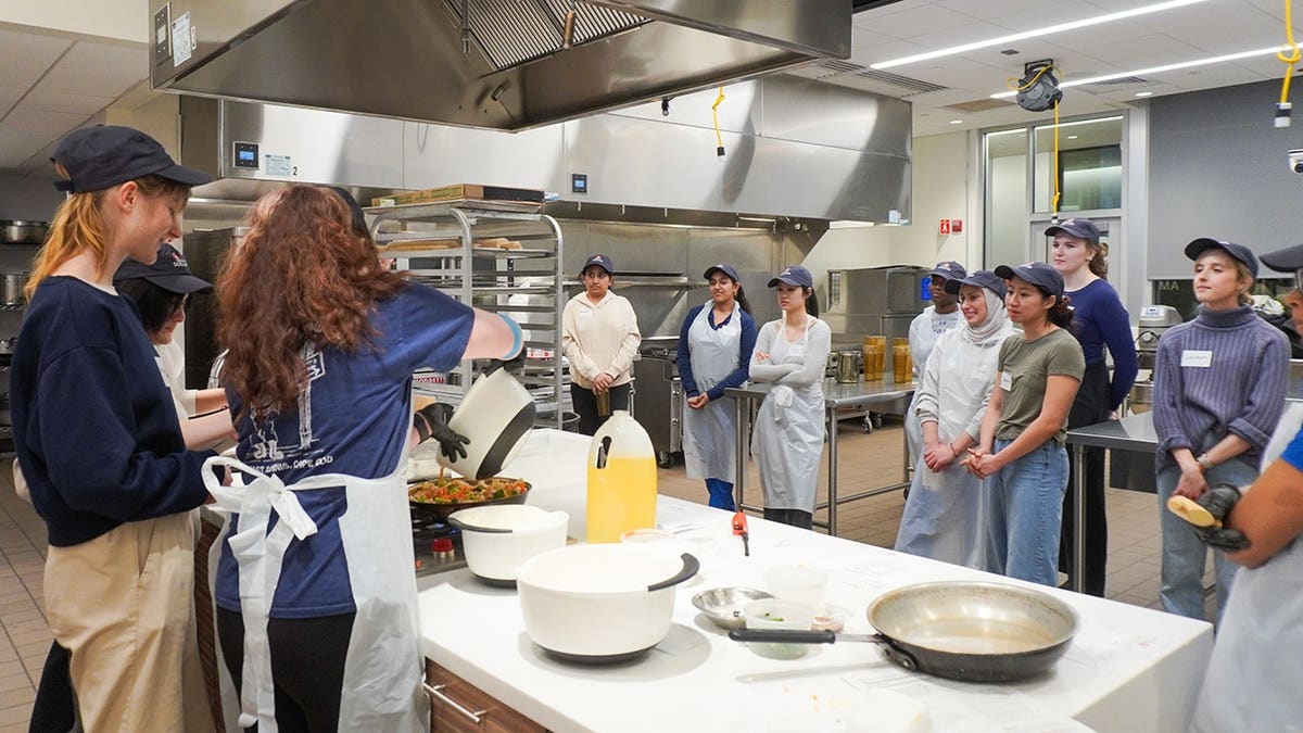 Students at Tuft's University learning in teaching kitchen.