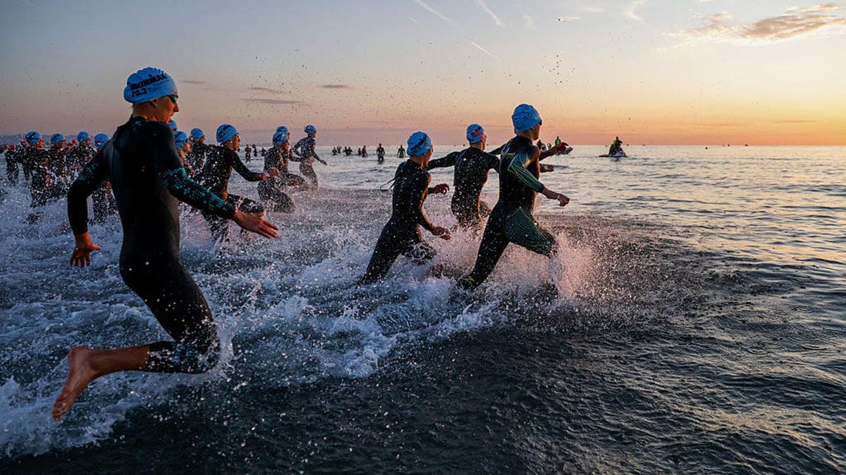 swimmers compete in triathlon