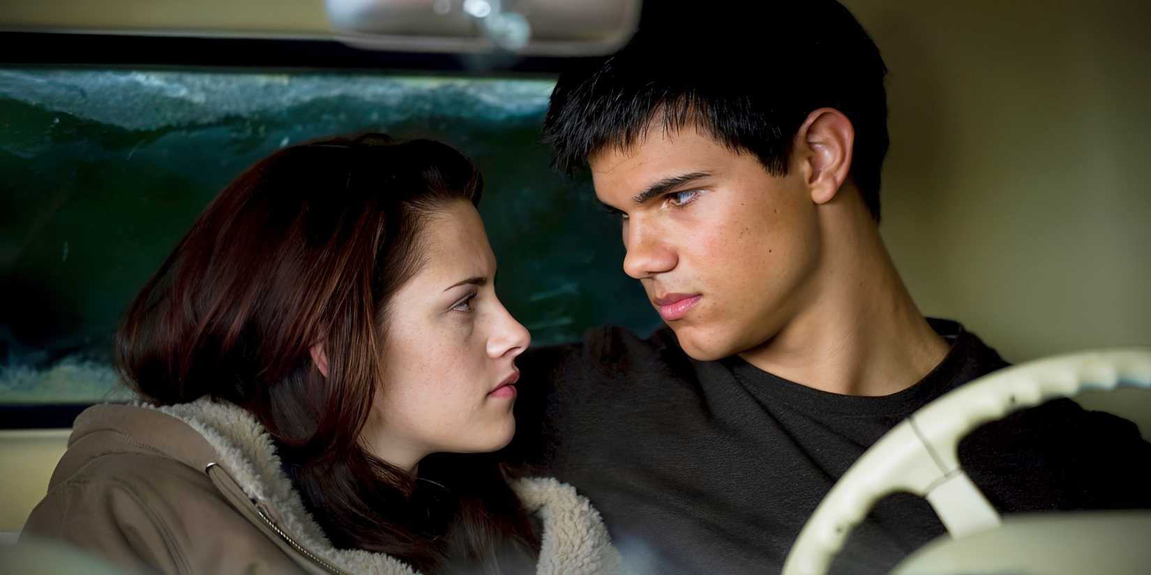 Taylor Lautner as Jacob sitting in his truck with Kristen Stewart as Bella Swan in Twilight.