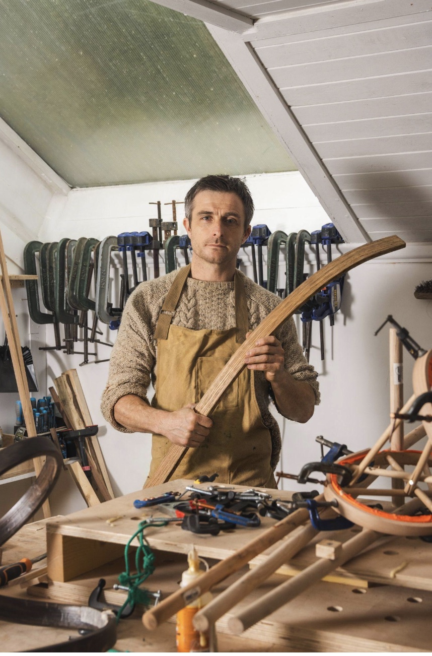 designer man holding a piece of wood