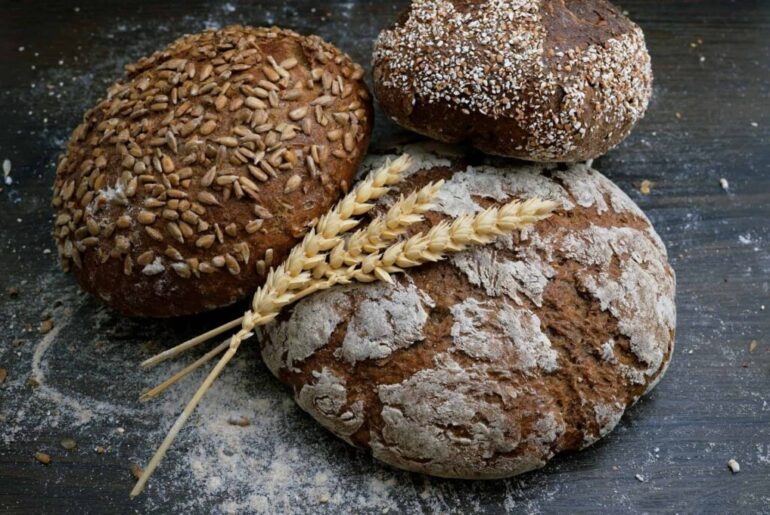 Artisanal bread with seeds and flour dust.