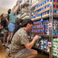 Three students work in the Blazer Kitchen food bank as part of the CURE nutritional program