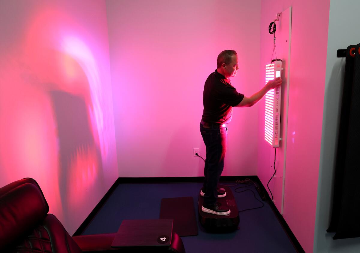 Shaun Grove demonstrates the recovery room infrared light station at Stride Fitness in Huntington Beach.