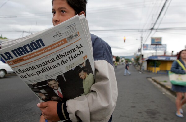 A vender sells La Nation newspapers in San Jose, Jan. 21, 2009. (AP Photo/Kent Gilbert, File)