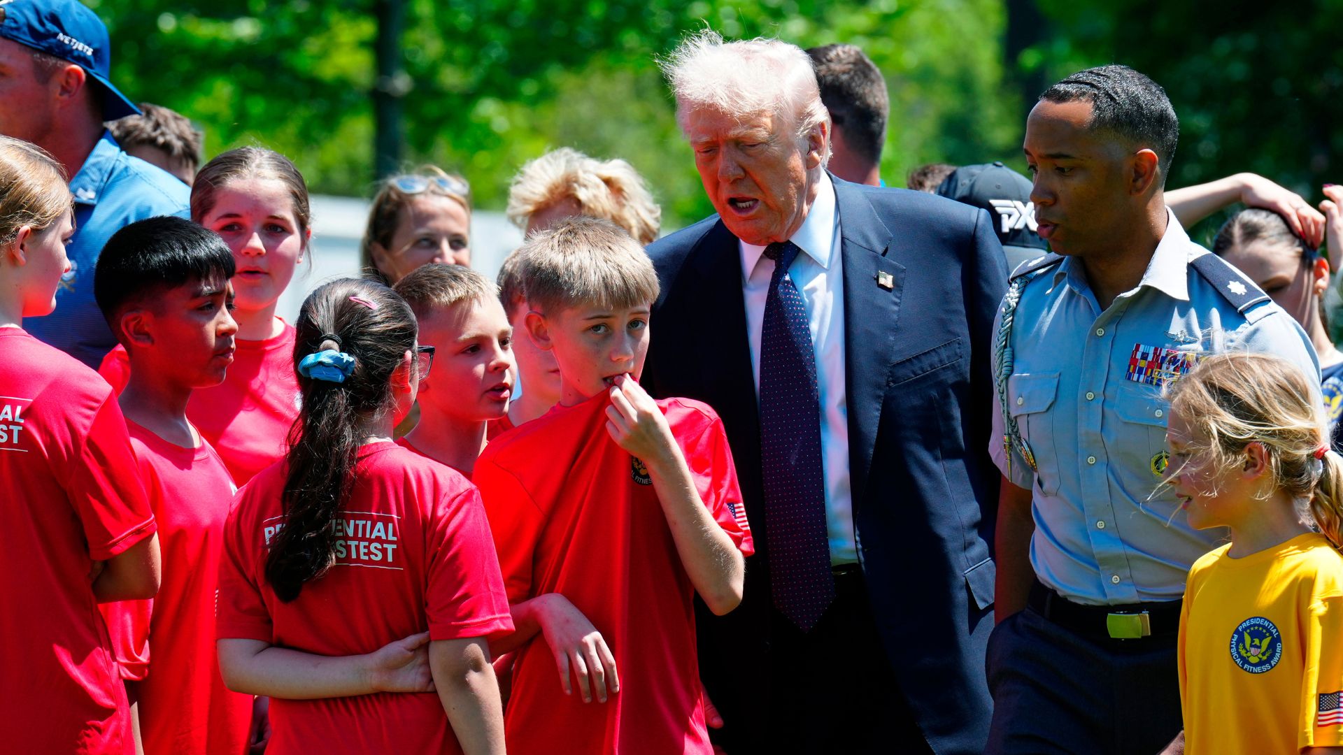 President Donald Trump walks with kids during exercise drills on the south lawn of the White House, Tuesday, May 5, 2026, in Washington.