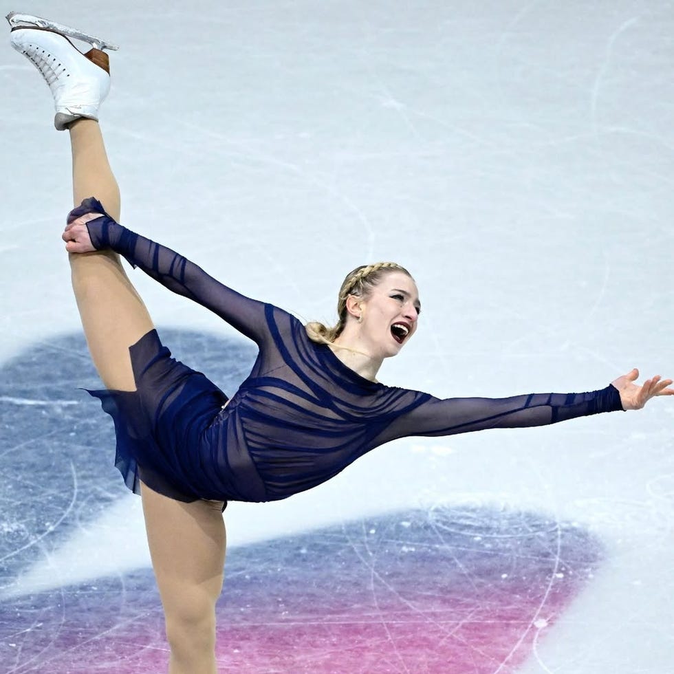 Figure skater performing a graceful pose on the ice.