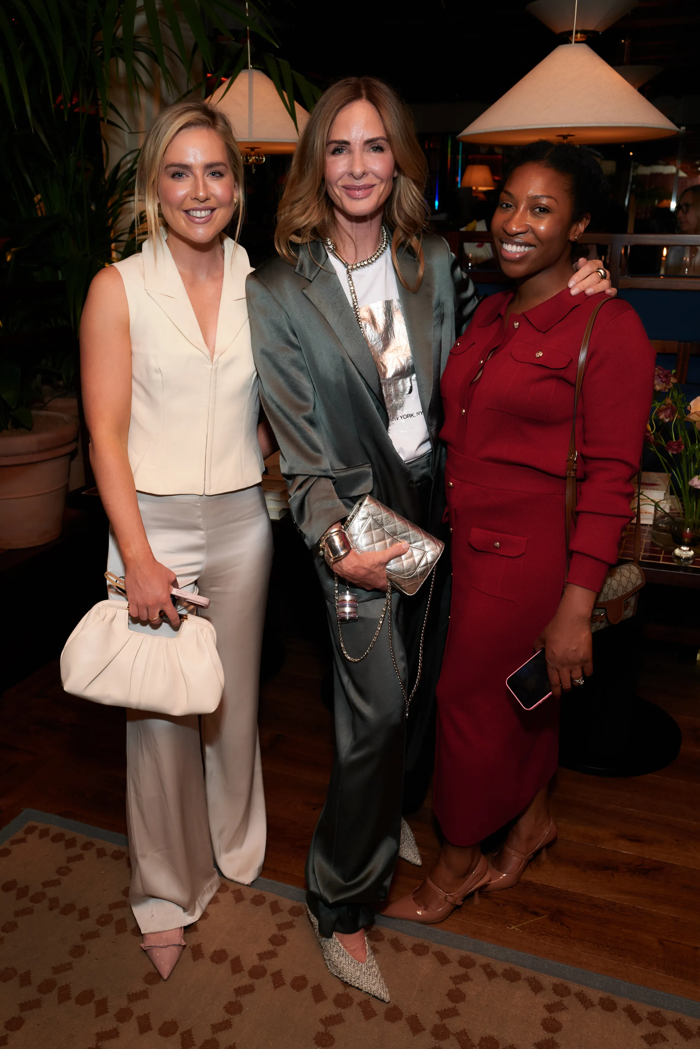 Three women smiling and posing for a photo.
