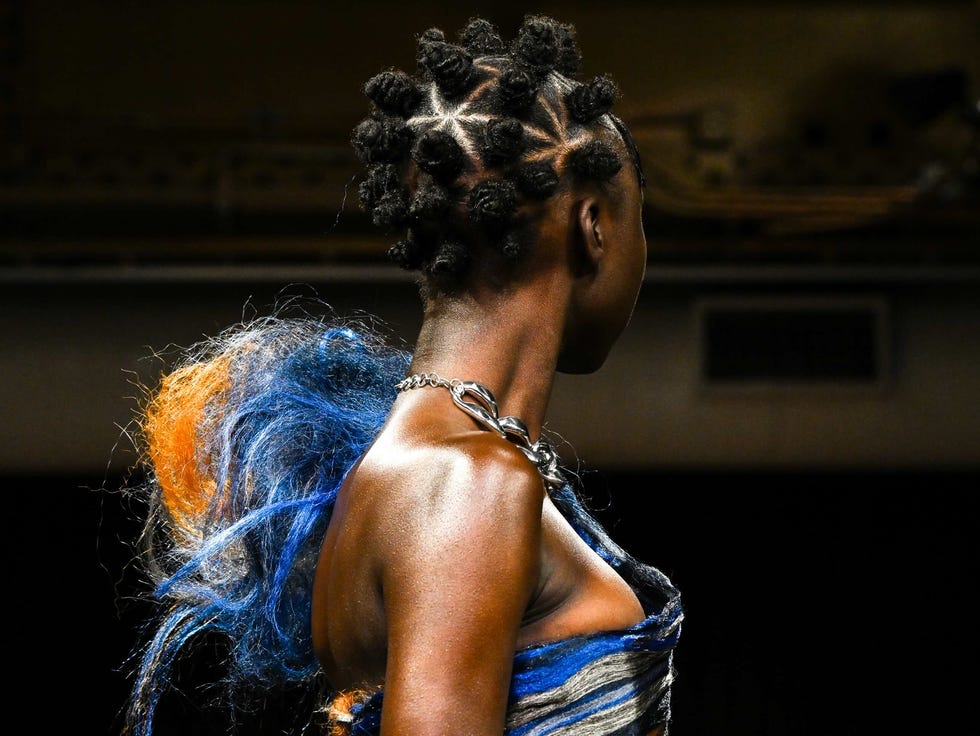 Fashion model showcasing a unique design with vibrant colors.