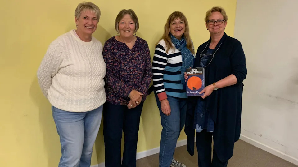 Eileen (second from the left) with three other members of one of her books club. One of them on the right is holding a copy of Bob Mortimer's book 'Satsuma'