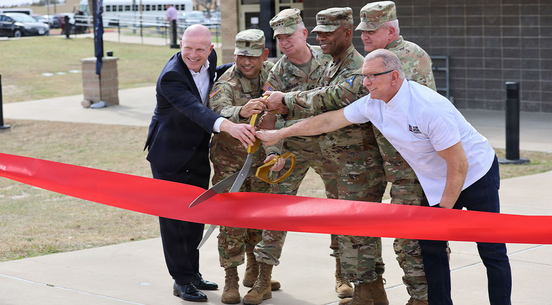 Chef Robert Irvine and LTG Chris Mohan and a ribbon cutting ceremony