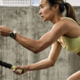 Woman performing a ropes exercise while wearing a Garmin watch