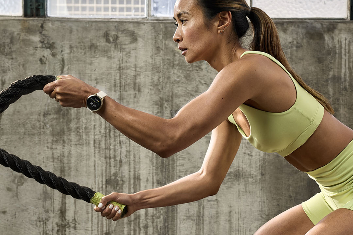 Woman performing a ropes exercise while wearing a Garmin watch