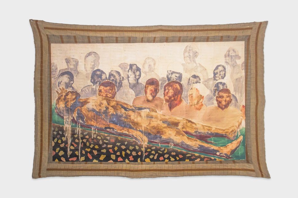 A large textile painting depicting reclining and standing human figures in muted earth tones hangs against a plain background, bordered by woven fabric.