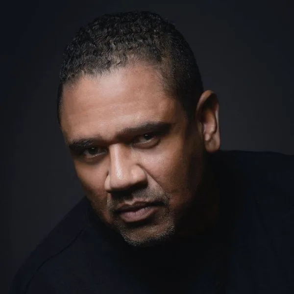 Simple and dramatic headshot of Keith L. Underwood in dark attire.