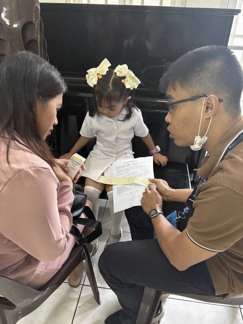 A health worker talks to a mother about her daughter's growth during a Child Nutrition Program screening held at the Caloocan Philippines Stake Center on Jan. 24, 2026.