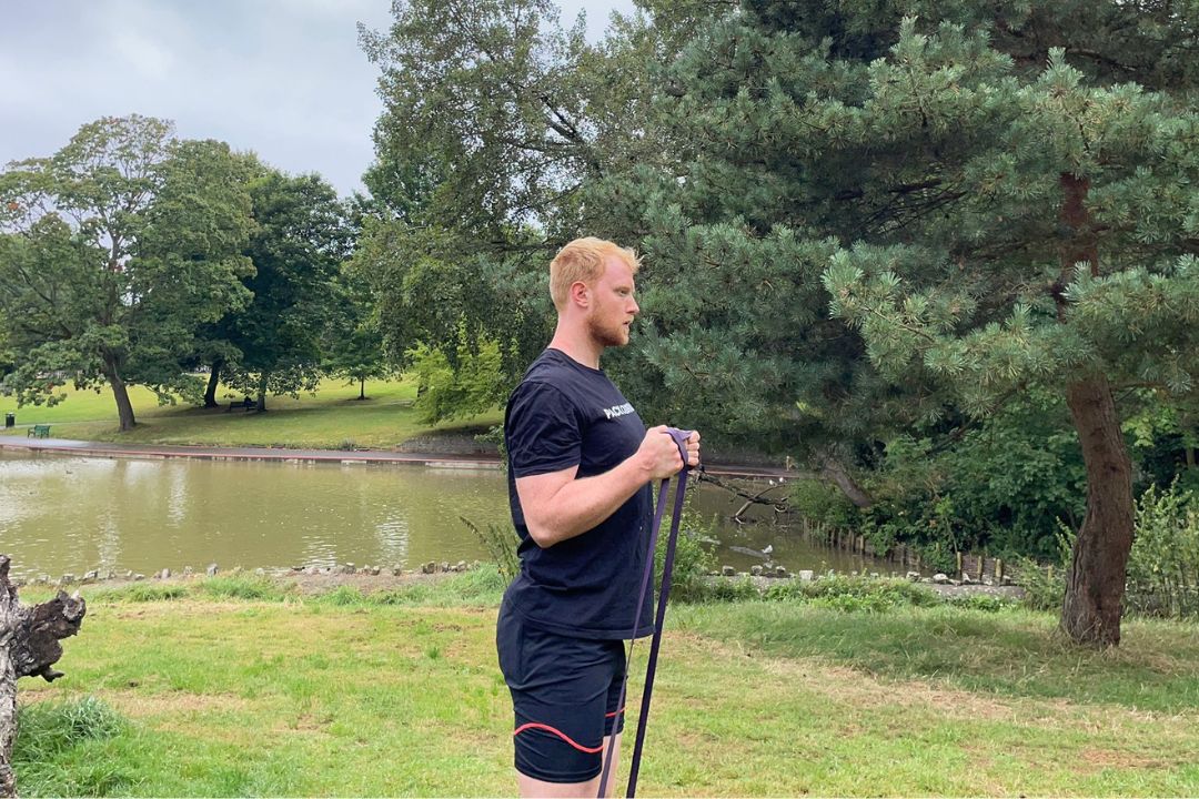 The Independent's senior fitness writer Harry Bullmore training with a resistance band