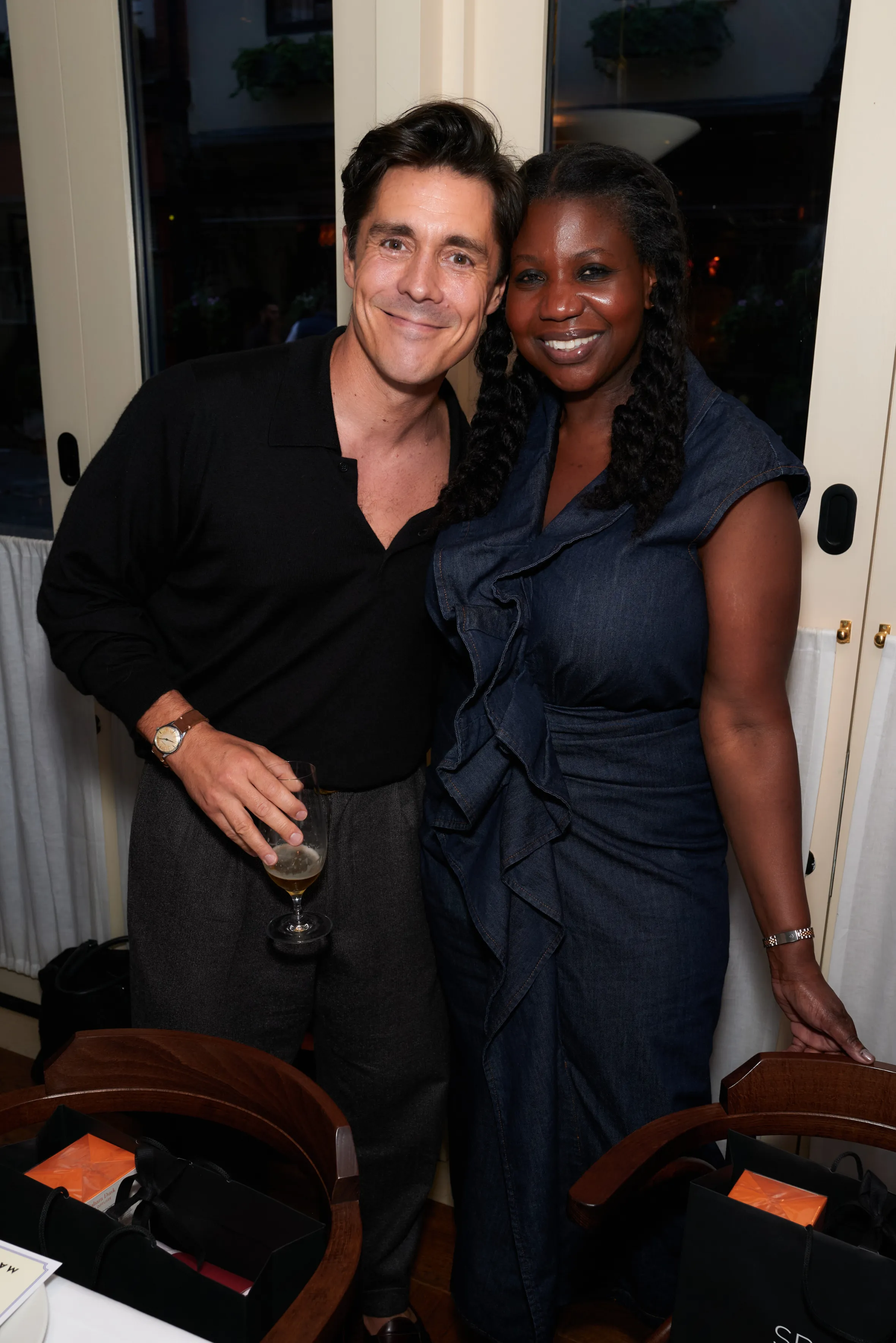 A man and a woman posing together, smiling for the camera.