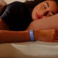 Woman wearing Google Fitbit Air while sleeping