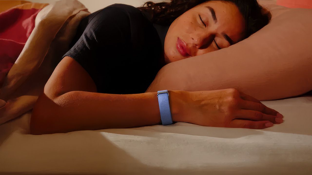 Woman wearing Google Fitbit Air while sleeping