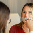 A health care provider administers a nasal vaccine. Photo by CDC on Unsplash