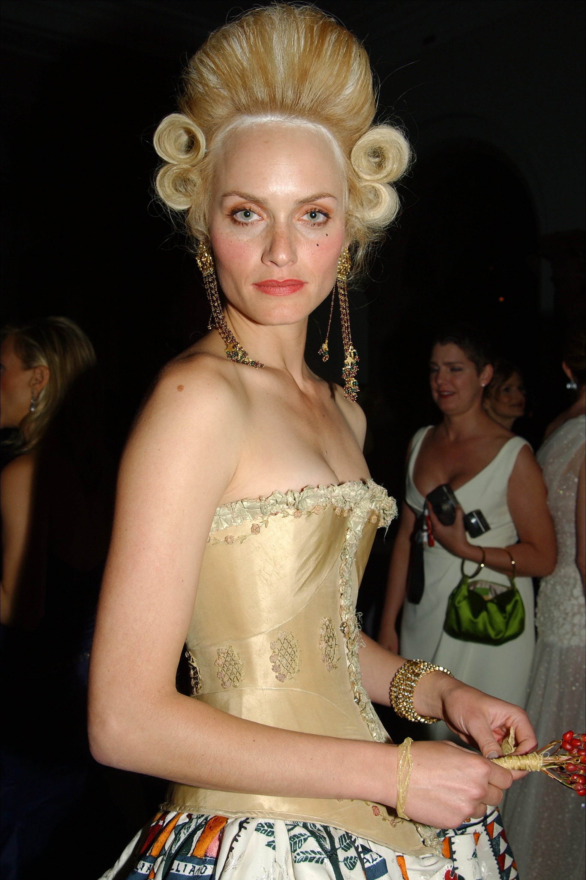 Amber Valletta wears an appropriate period coif as she atten