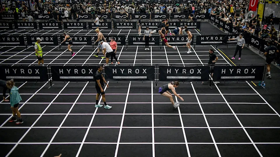 Participants performing burpee broad jumps at Hyrox fitness race in Bangkok