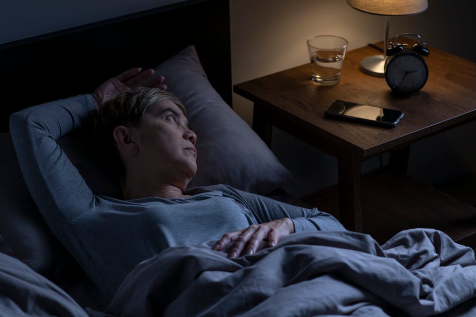 longevity tips for midlife: woman waking up during the night