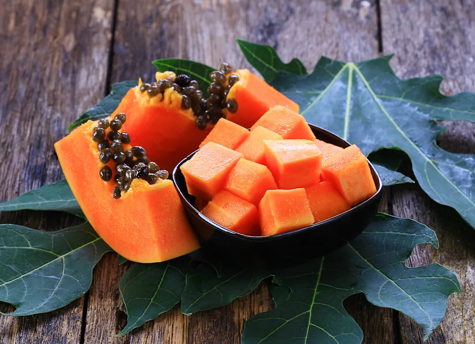 sliced papaya on old wooden