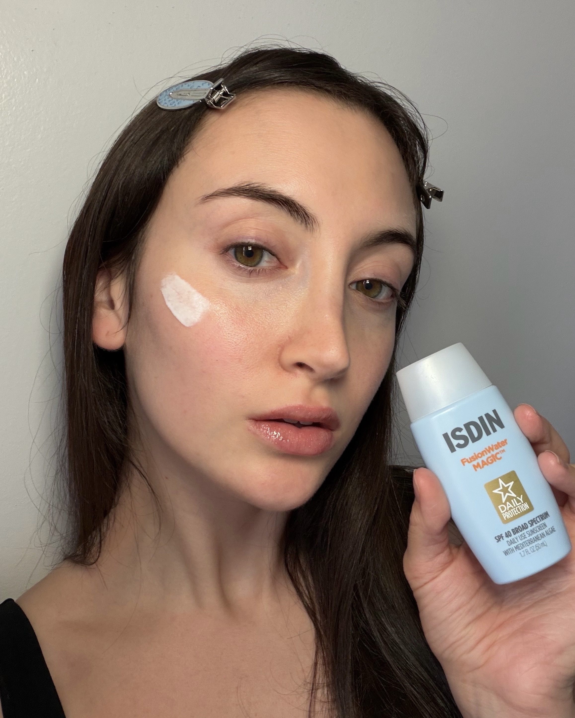 An image of WWW associate beauty editor Alyssa Brascia testing the Isdin Fusion Water sunscreen.