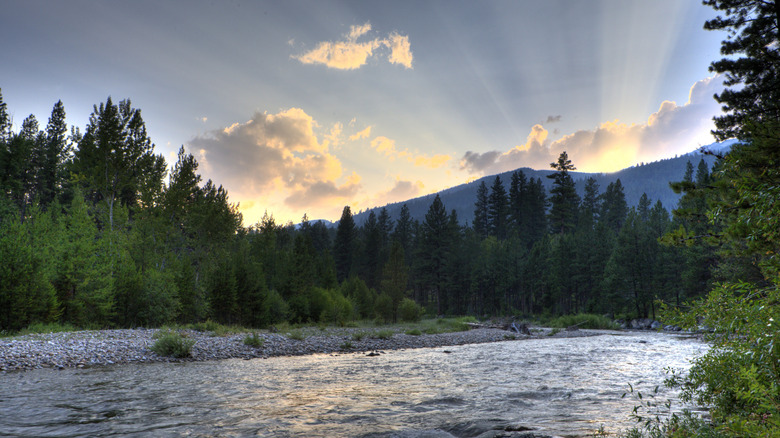 Bitterroot River with sun setting behind mountain in background