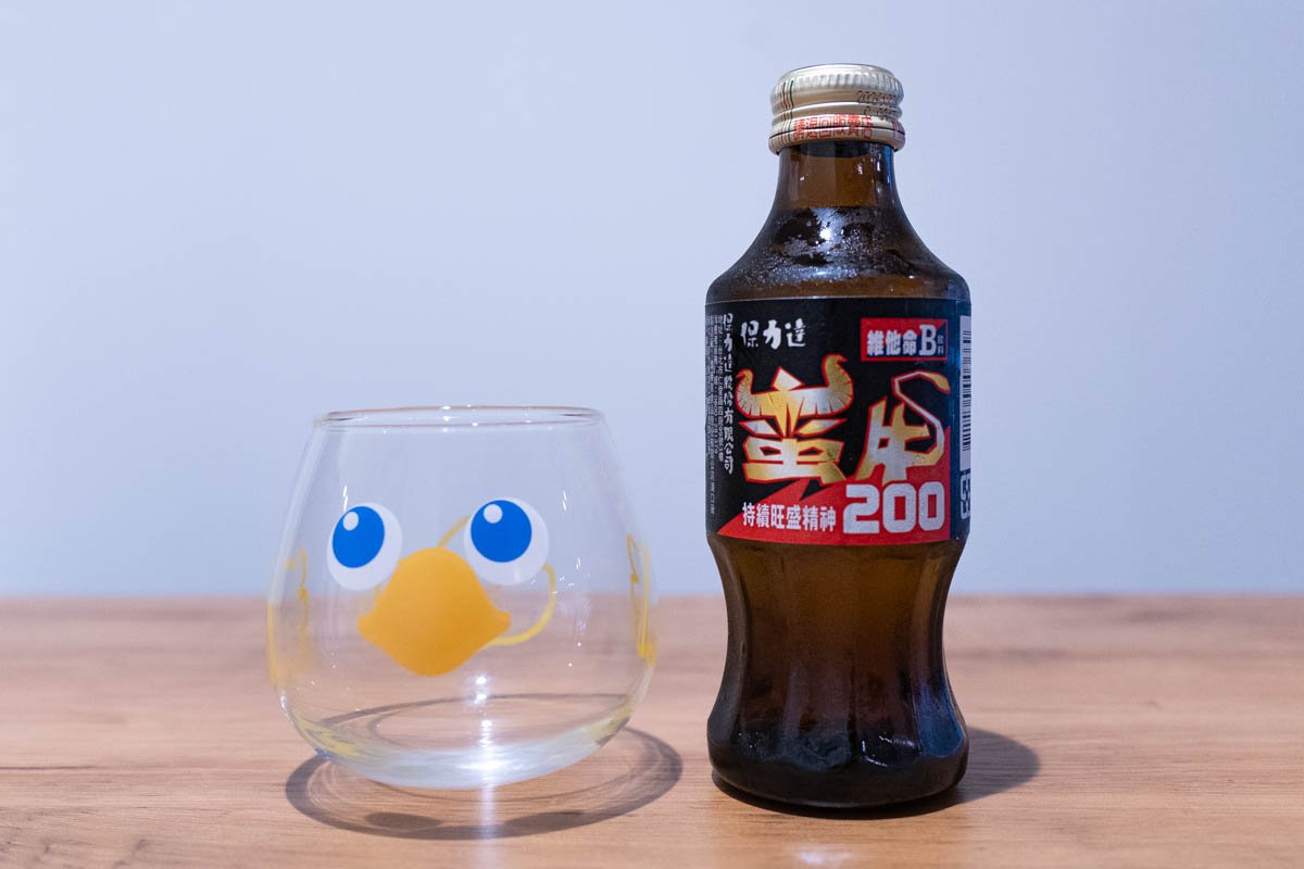 Man-New Vitamin B Drink and a glass