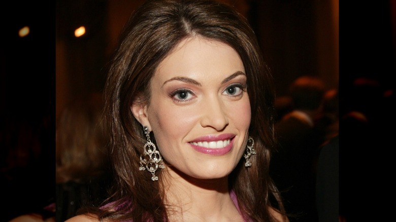 Kimberly Guilfoyle smiling at an event in 2003 wearing dangly earrings.