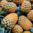Fresh pineapples piled together at a market linked to reducing sweet and chocolate cravings after meals