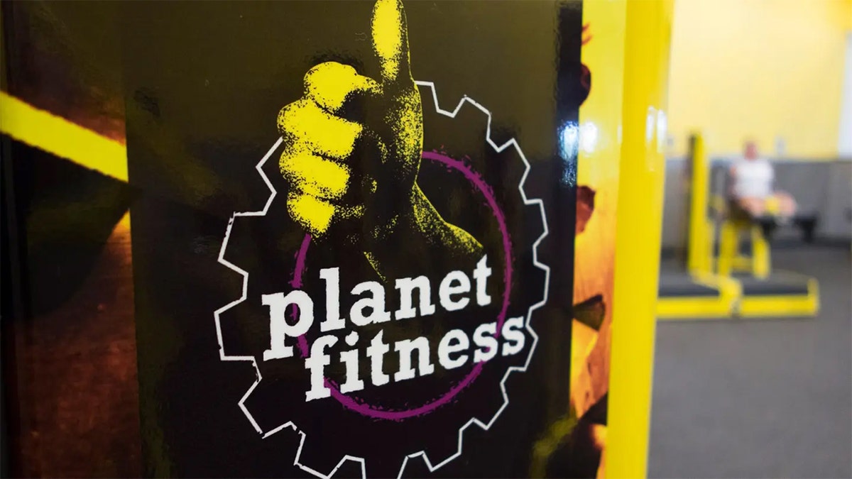 Family members standing outside a Planet Fitness gym in Indianapolis
