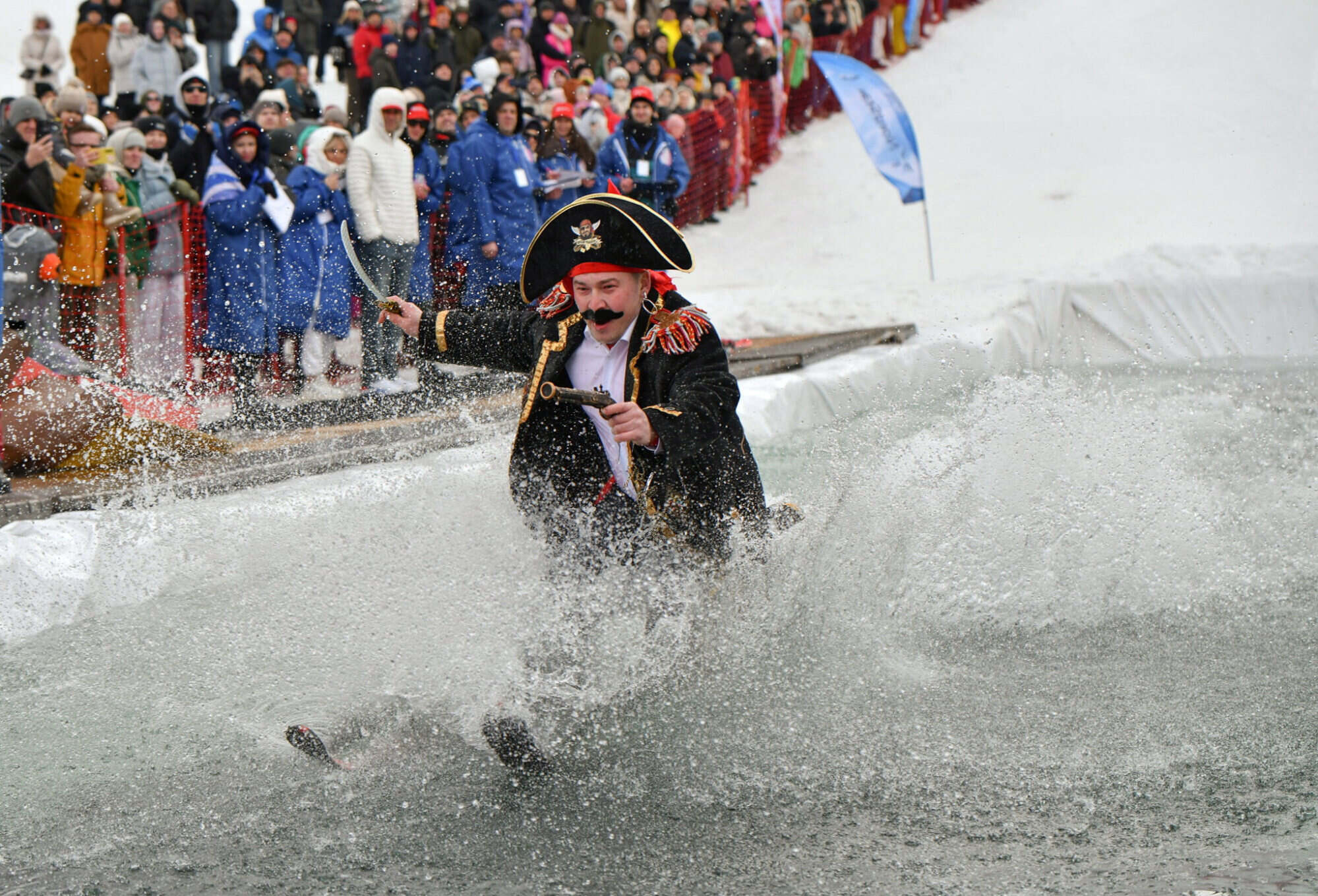 A skier attempts to cross a pool of water at the foot of a slope in Krasnoyarsk, Russia. Photo: Reuters