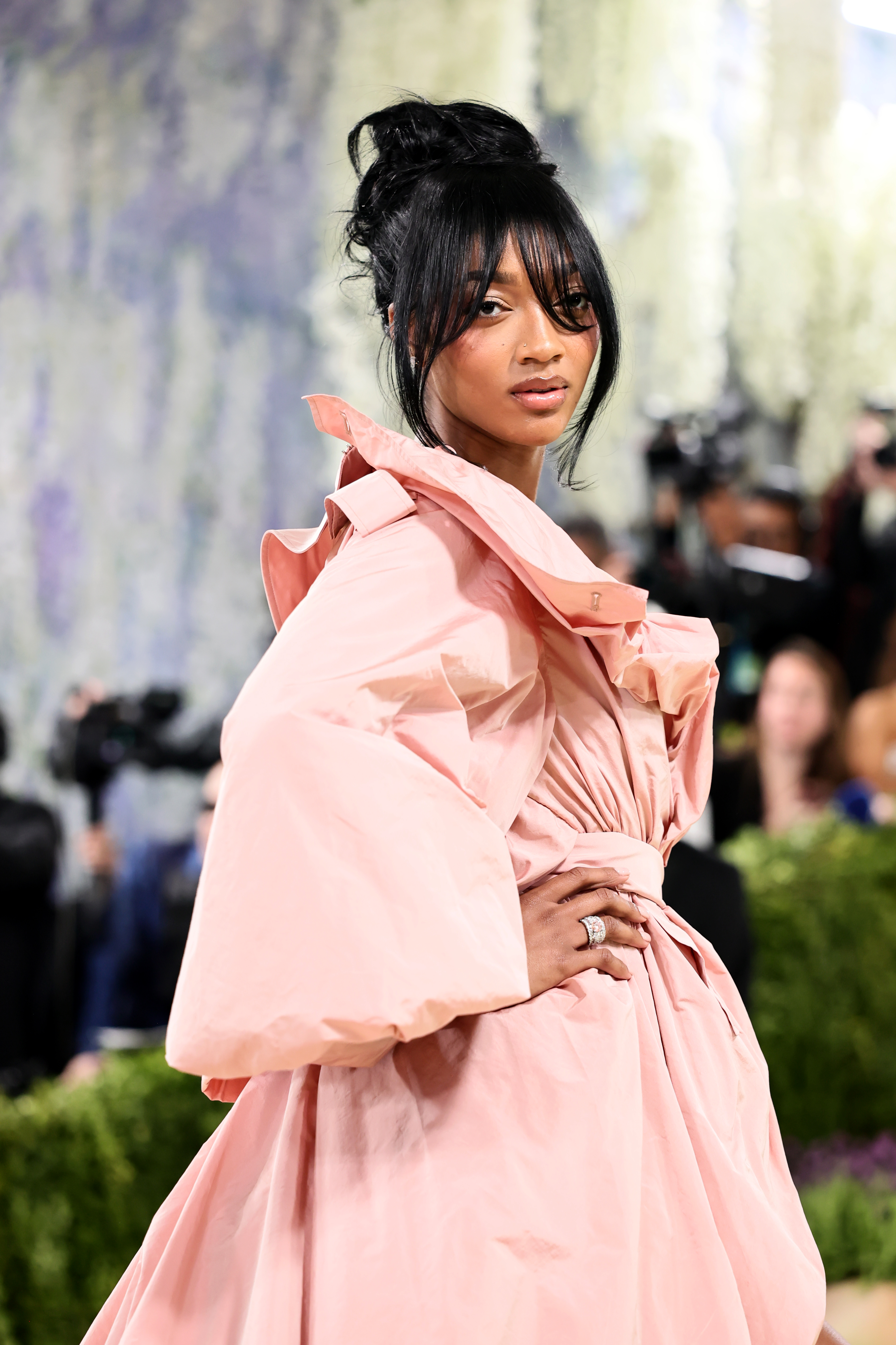 a woman in a pink gown with a brunette updo