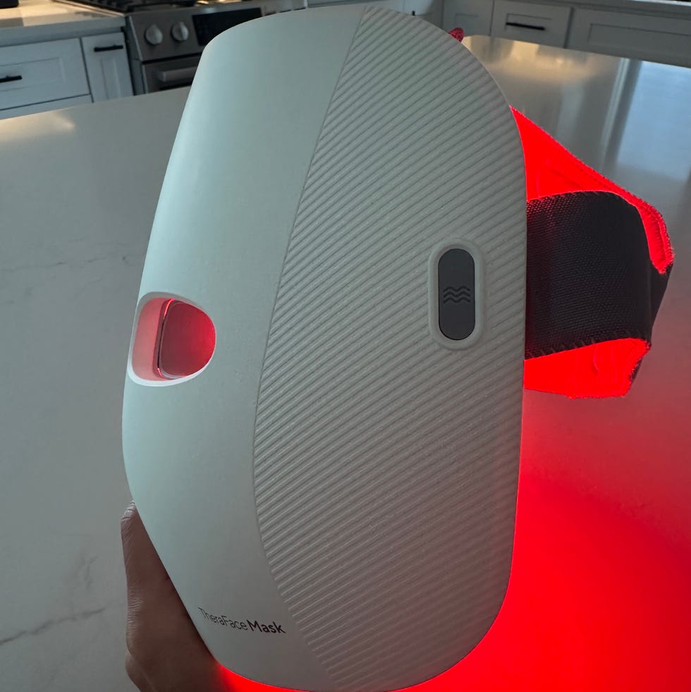 a person holding a red and white cell phone