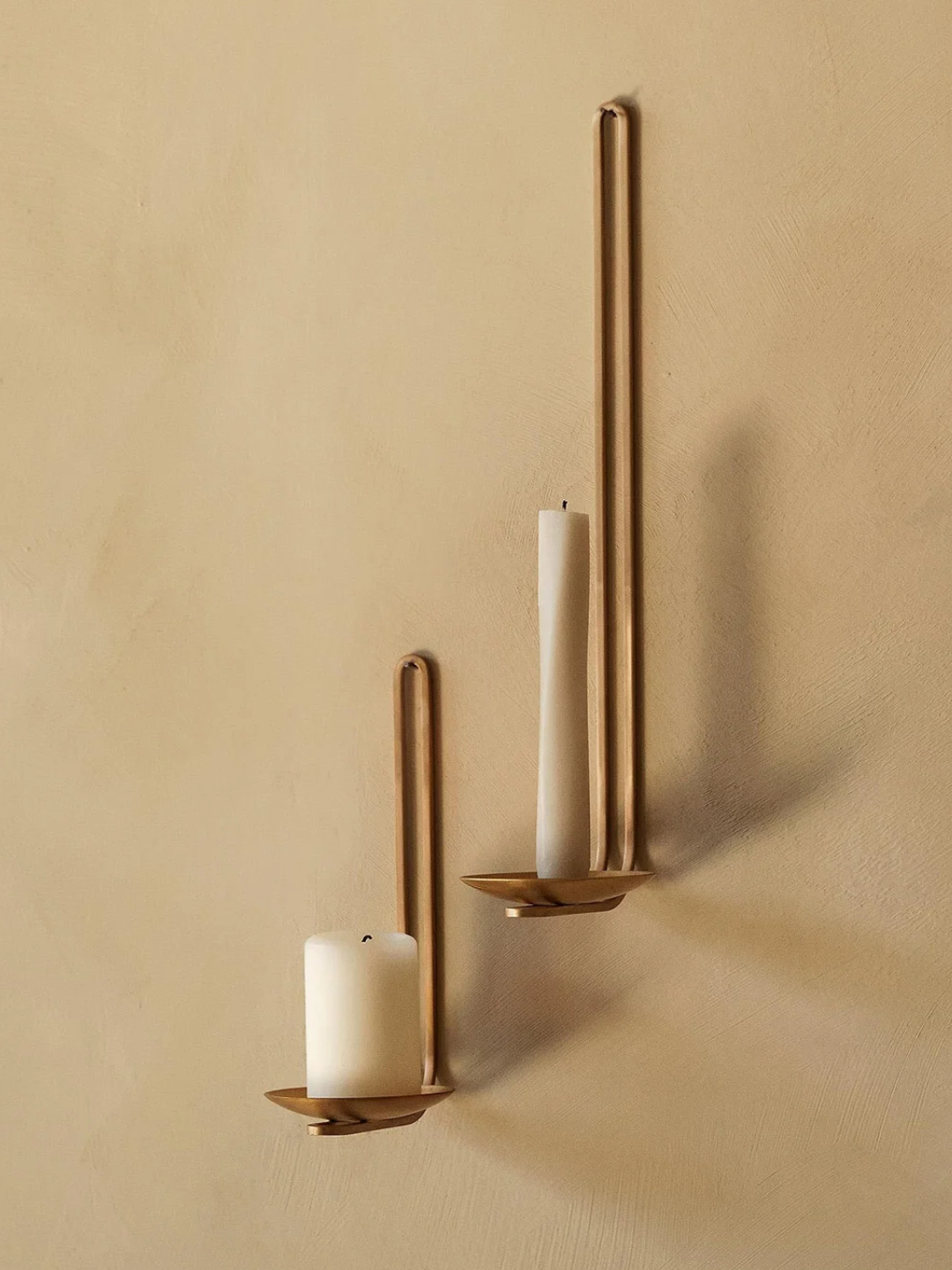 A pair of clip wall candle holders in brass