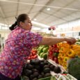 woman shopping for fresh produce at a farmers market