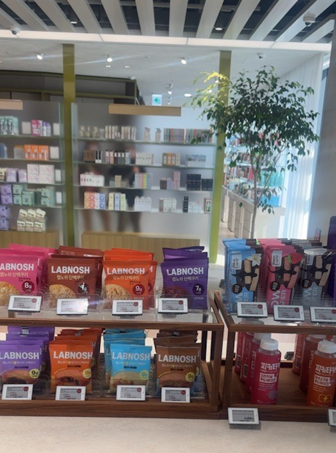 Assorted health snacks and drinks displayed in a modern store at Olive Young Seoul, Korea