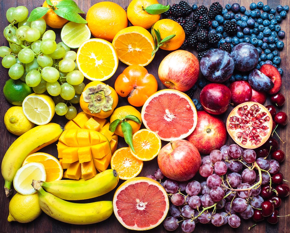 Fruit Board 1 A variety of fresh fruits, including berries, citrus, grapes, bananas, apples, mango and pomegranate, are displayed together in an illustration accompanying dietitians’ advice on common nutrition myths and misconceptions about healthy eating.