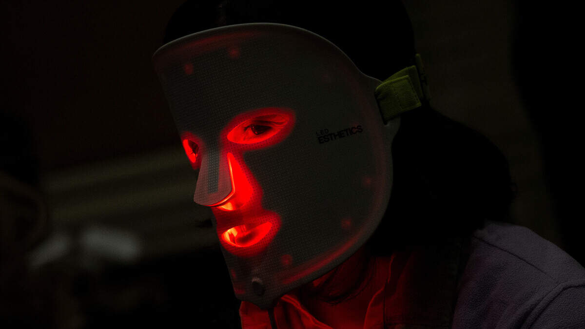 Wellness retreats are expensive. These expert tips help you create the experience at home. A person wears a red light mask from Light Tree Ventures during Pepcom’s Digital Experience at the The Mirage resort during the Consumer Electronics Show (CES) in Las Vegas, Nevada on January 8, 2024.